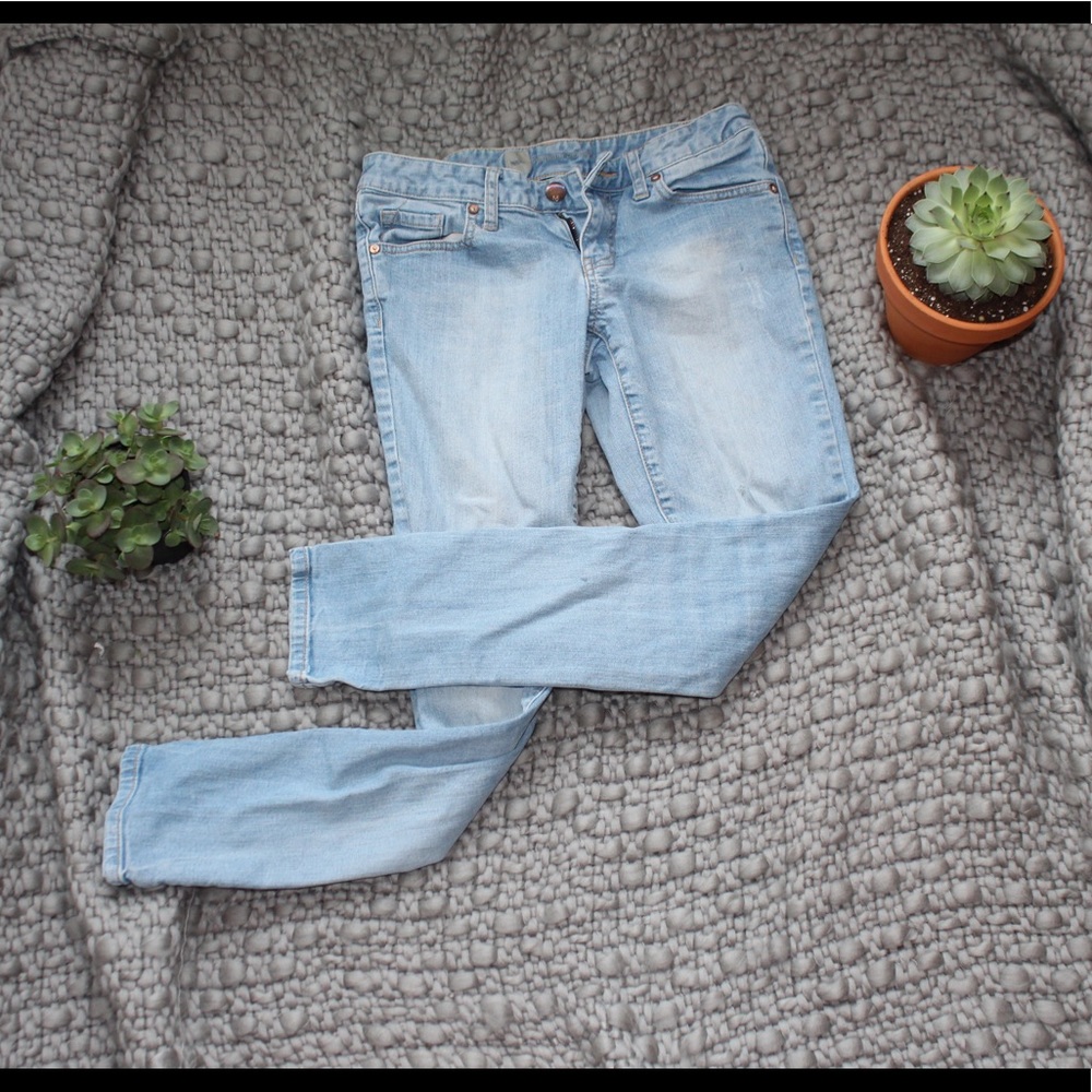 mid light wash with one slight stain on left thigh